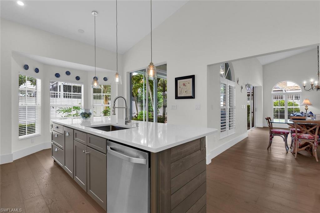 2124 Paget Circle, Unit 1 Naples, FL 34112 - Photo 4 of 31 a kitchen with stainless steel appliances granite countertop a stove and a wooden floors