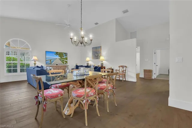 a view of a dining room with furniture and a chandelier