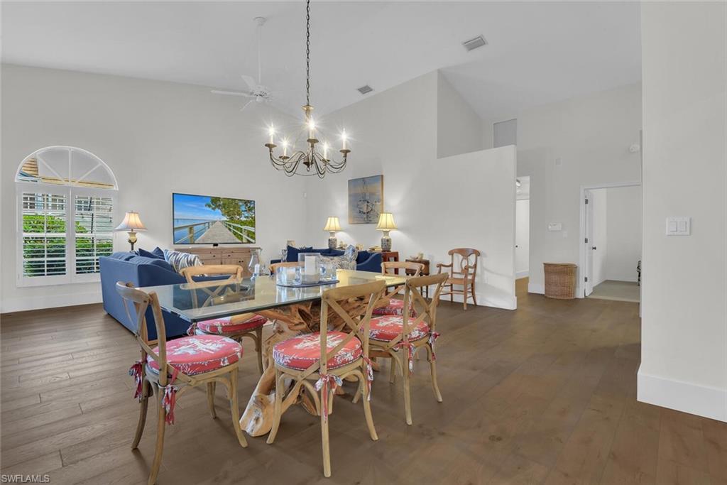 2124 Paget Circle, Unit 1 Naples, FL 34112 - Photo 5 of 31 a view of a dining room with furniture and a chandelier
