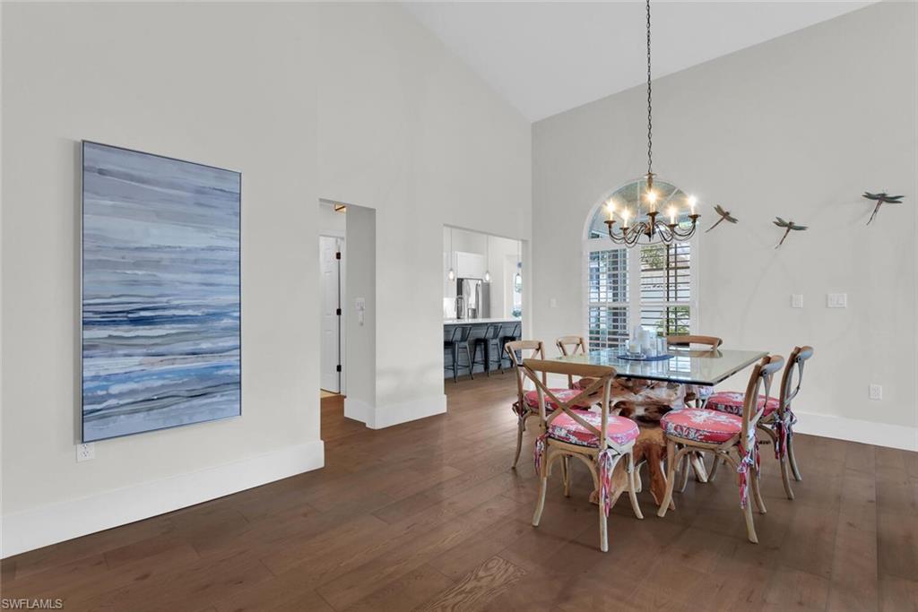 2124 Paget Circle, Unit 1 Naples, FL 34112 - Photo 6 of 31 a view of a dining room with furniture and chandelier