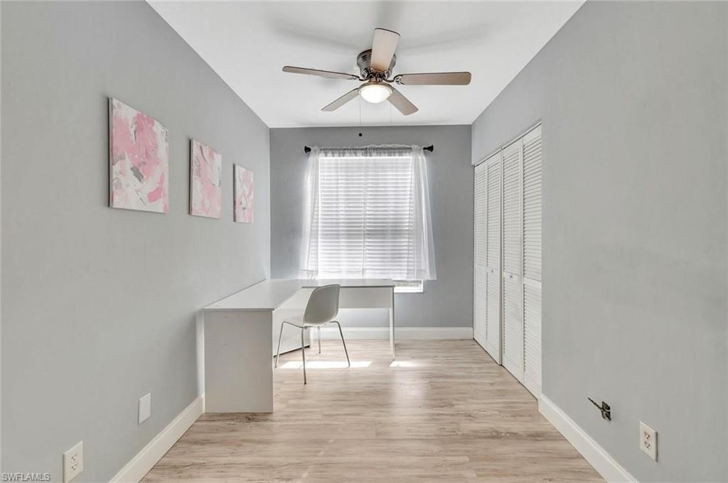 1965 Courtyard Way, Unit E106 Naples, FL 34112 - Photo 10 of 15 a view of room with window and wooden floor