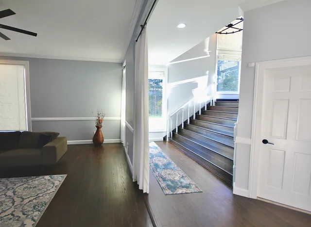 a living room with furniture and wooden floor