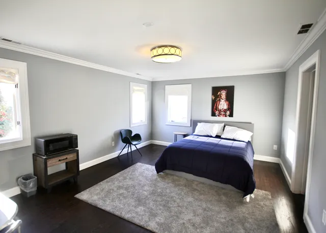 a bedroom with a bed and a couch