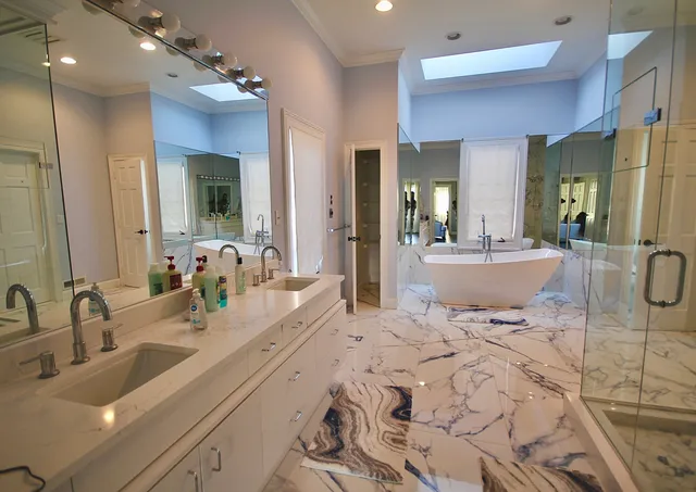 a bathroom with double vanity sinks a vanity a mirror and shower
