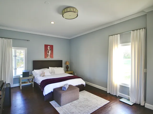 a bedroom with a bed and a window