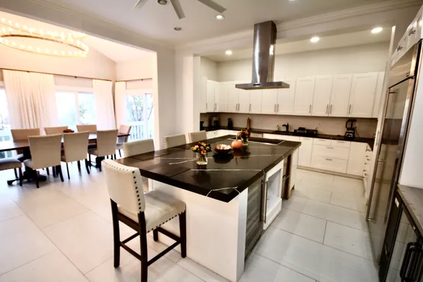 a kitchen with a stove a sink a counter top space and appliances