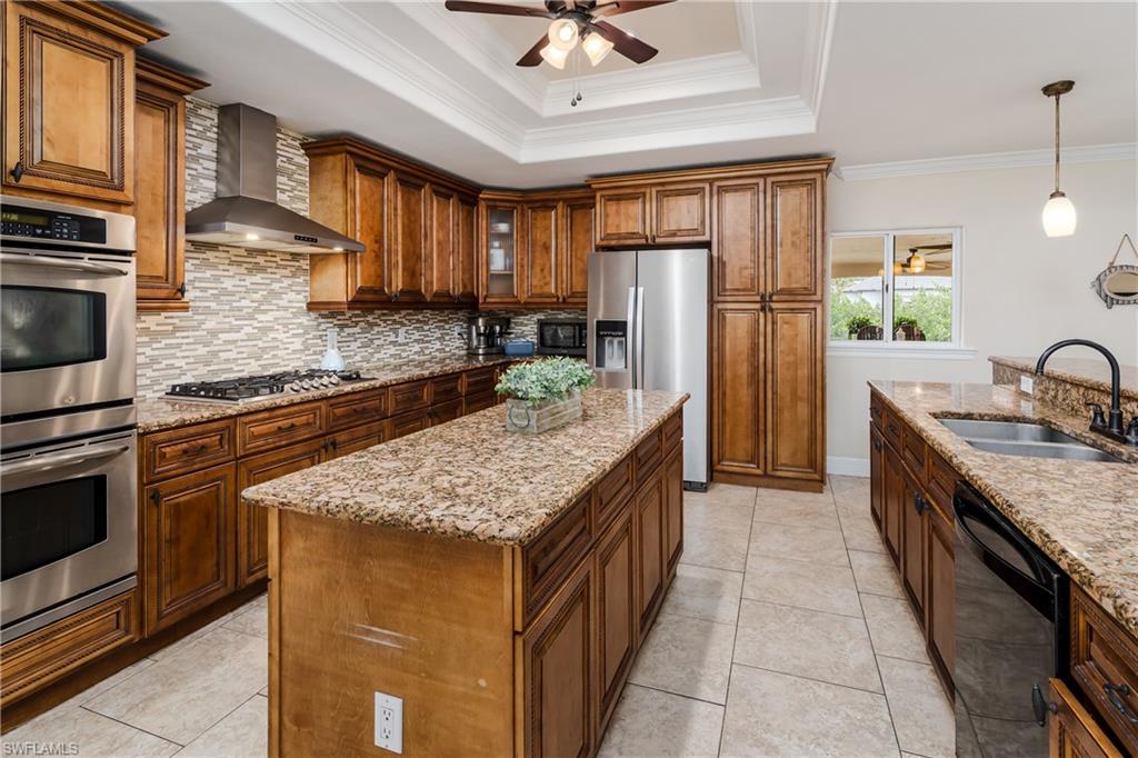 1781 21st Street Southwest Naples, FL 34117 - Photo 11 of 39 a kitchen with stainless steel appliances granite countertop a sink stove and refrigerator
