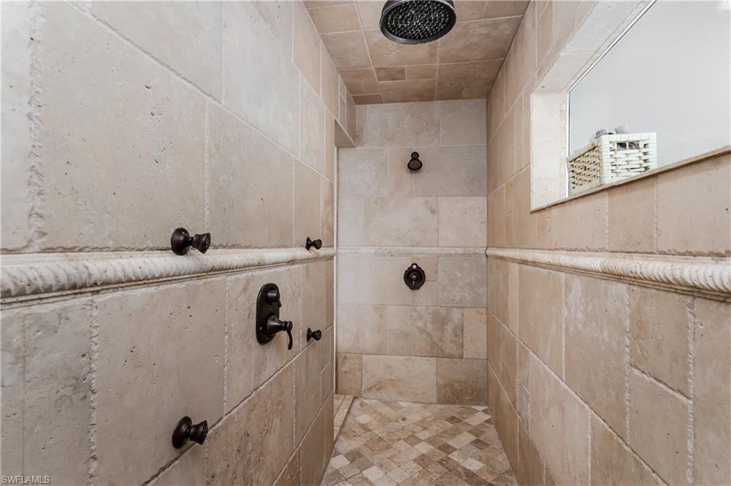 1781 21st Street Southwest Naples, FL 34117 - Photo 19 of 39 a bathroom with a sink a mirror and shower