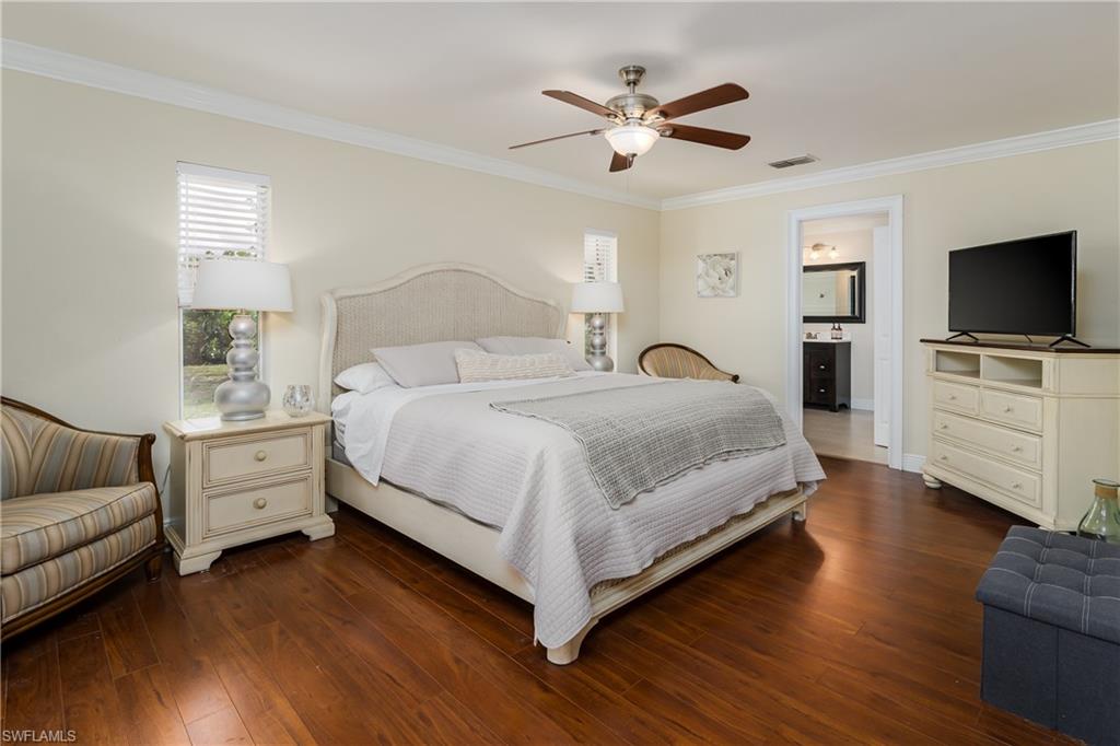 1781 21st Street Southwest Naples, FL 34117 - Photo 20 of 39 a spacious bedroom with a bed and a couch