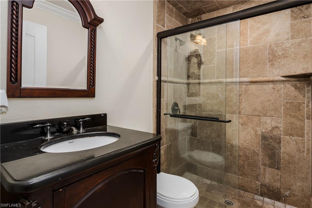 1781 21st Street Southwest Naples, FL 34117 - Photo 25 of 39 a bathroom with a sink toilet a mirror and shower