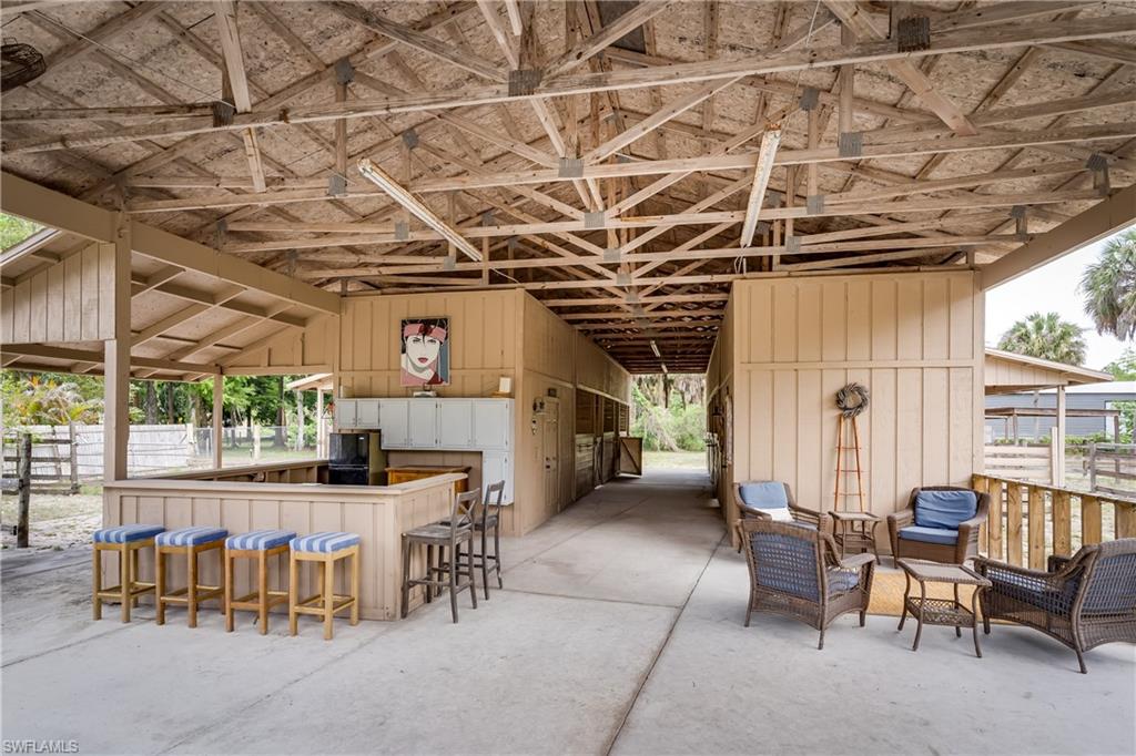 1781 21st Street Southwest Naples, FL 34117 - Photo 31 of 39 a view of a chairs and table in a patio
