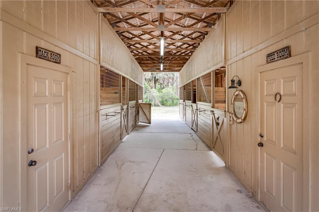 1781 21st Street Southwest Naples, FL 34117 - Photo 33 of 39 a hallway with wooden floor chandelier