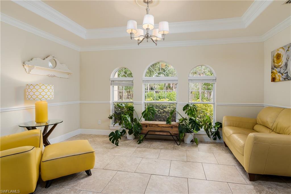 1781 21st Street Southwest Naples, FL 34117 - Photo 5 of 39 a living room with furniture and a chandelier