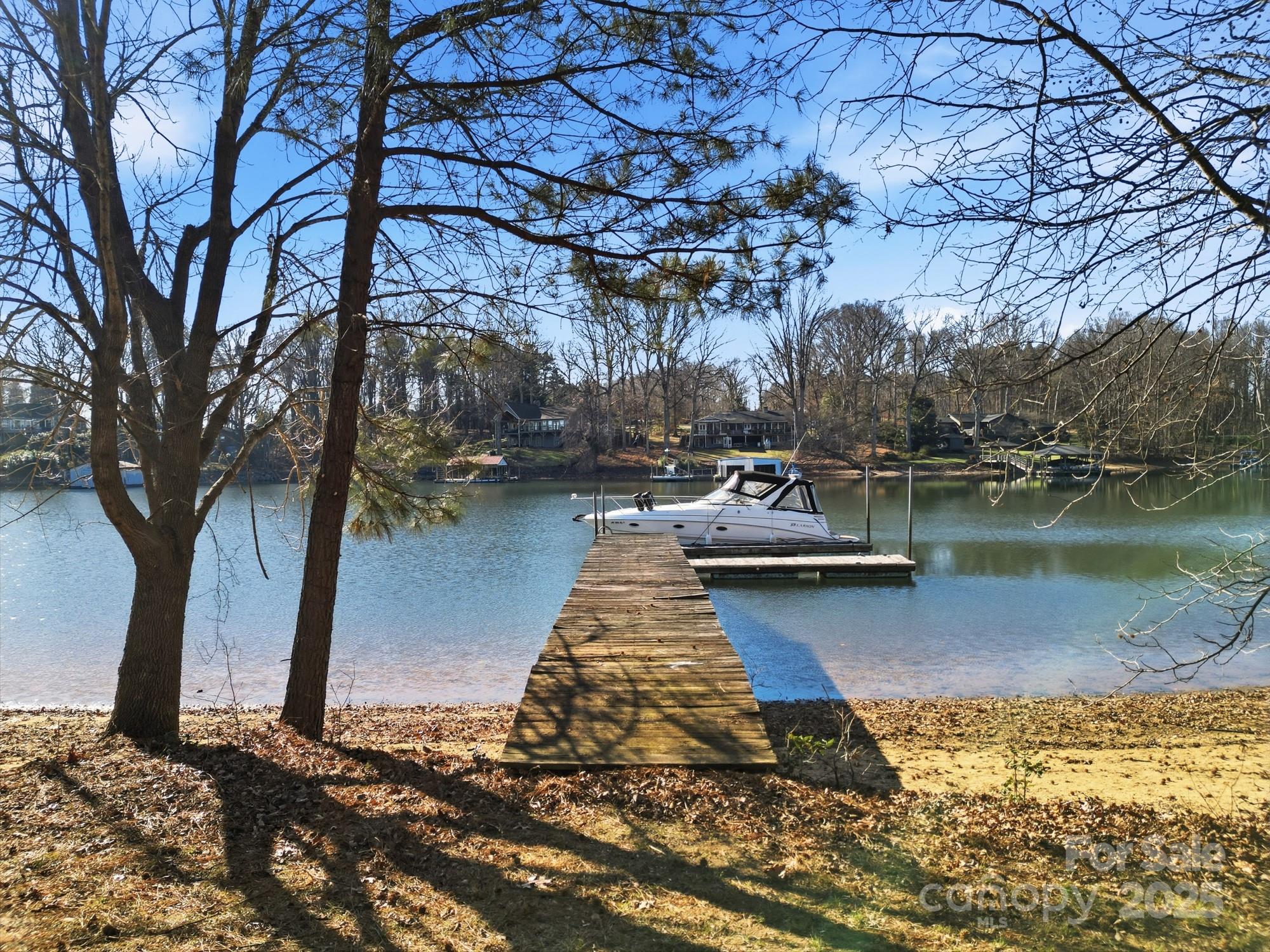 168 Willow Point Road Troutman, NC 28166 - Photo 10 of 16 a view of a lake with boats and trees