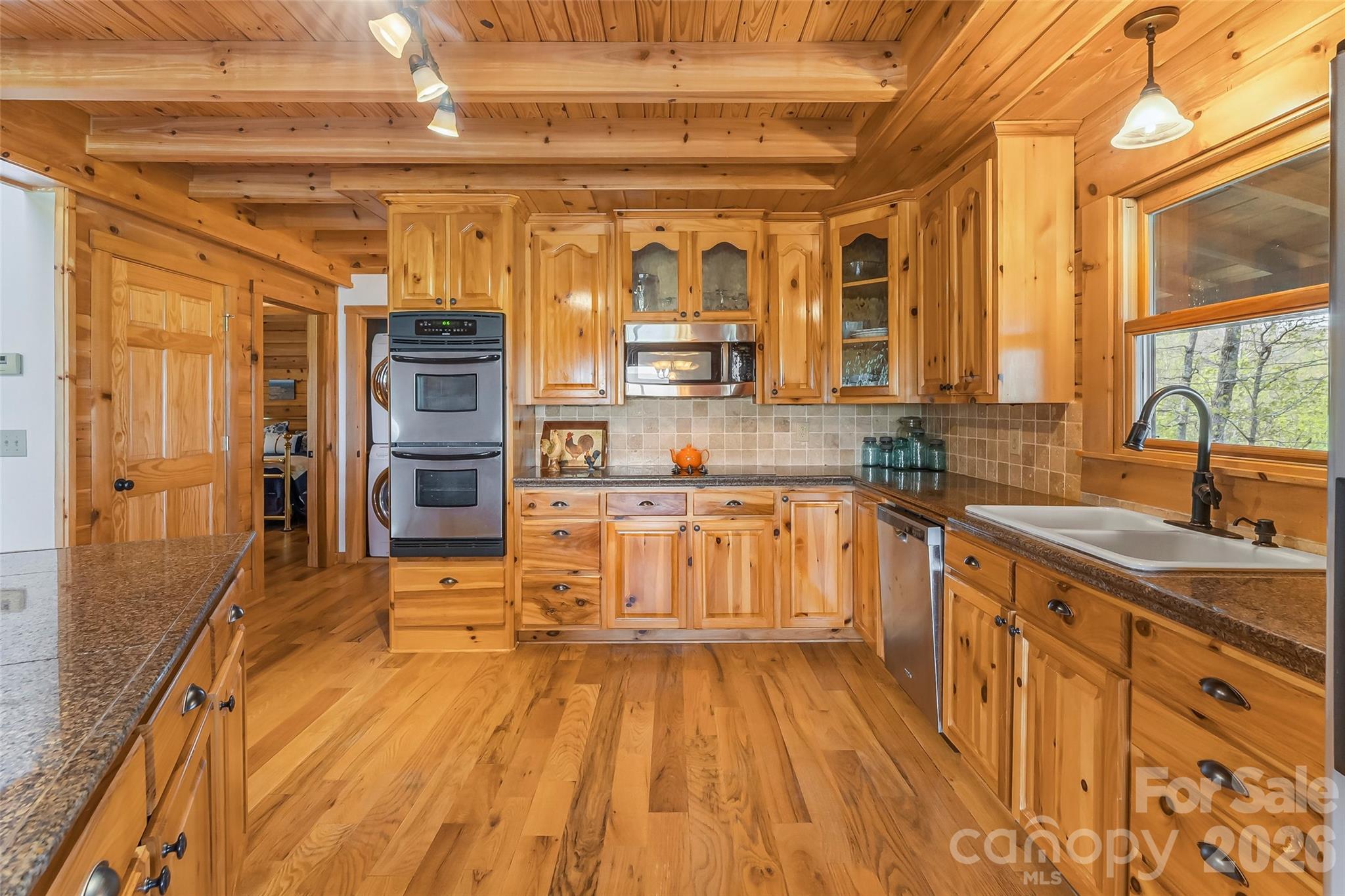 295 Outback Trail, Unit 29 Nebo, NC 28761 - Photo 17 of 46 a large kitchen with stainless steel appliances wooden floor and large windows