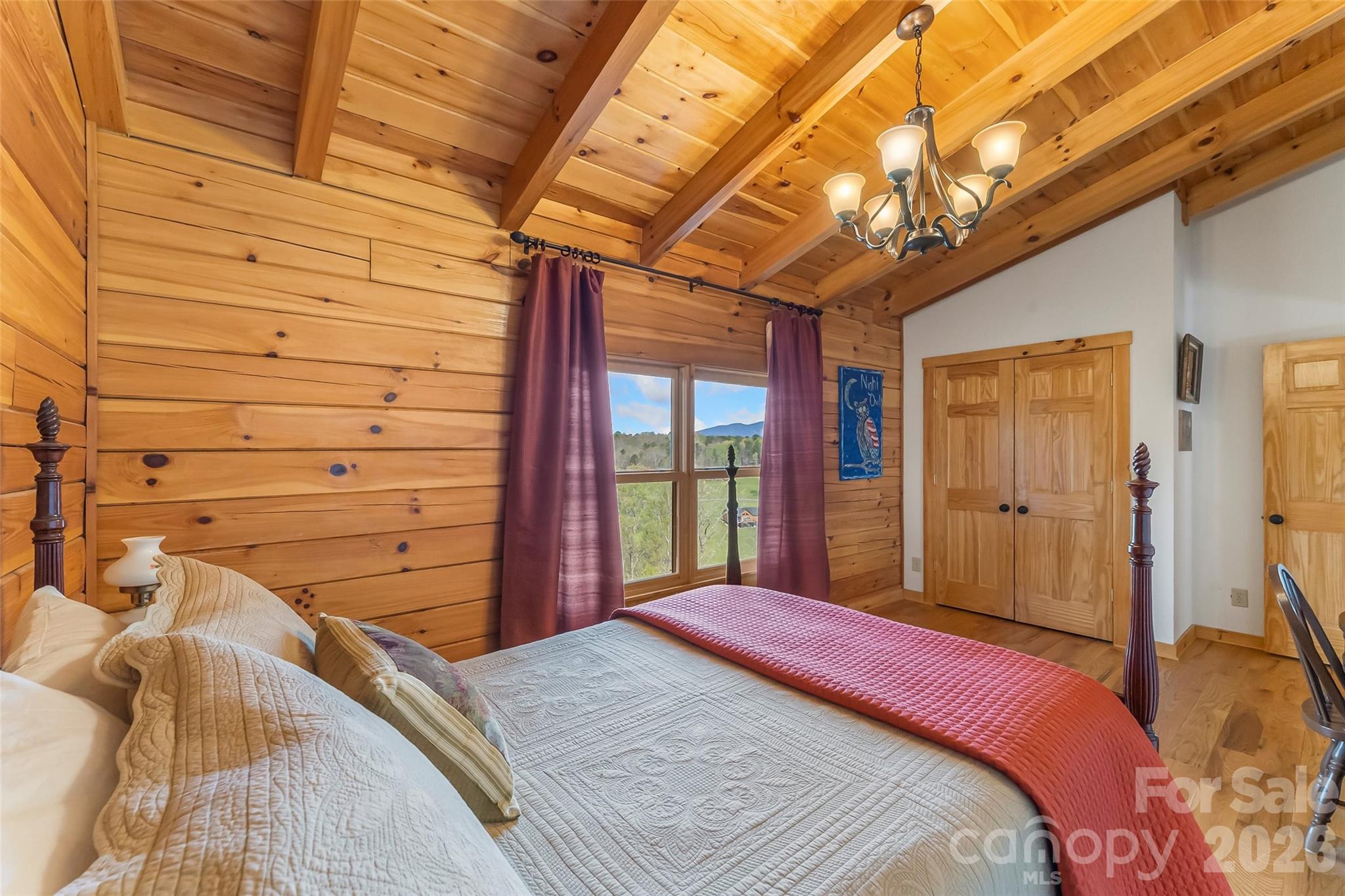 295 Outback Trail, Unit 29 Nebo, NC 28761 - Photo 29 of 46 a bed sitting in a bedroom next to a window