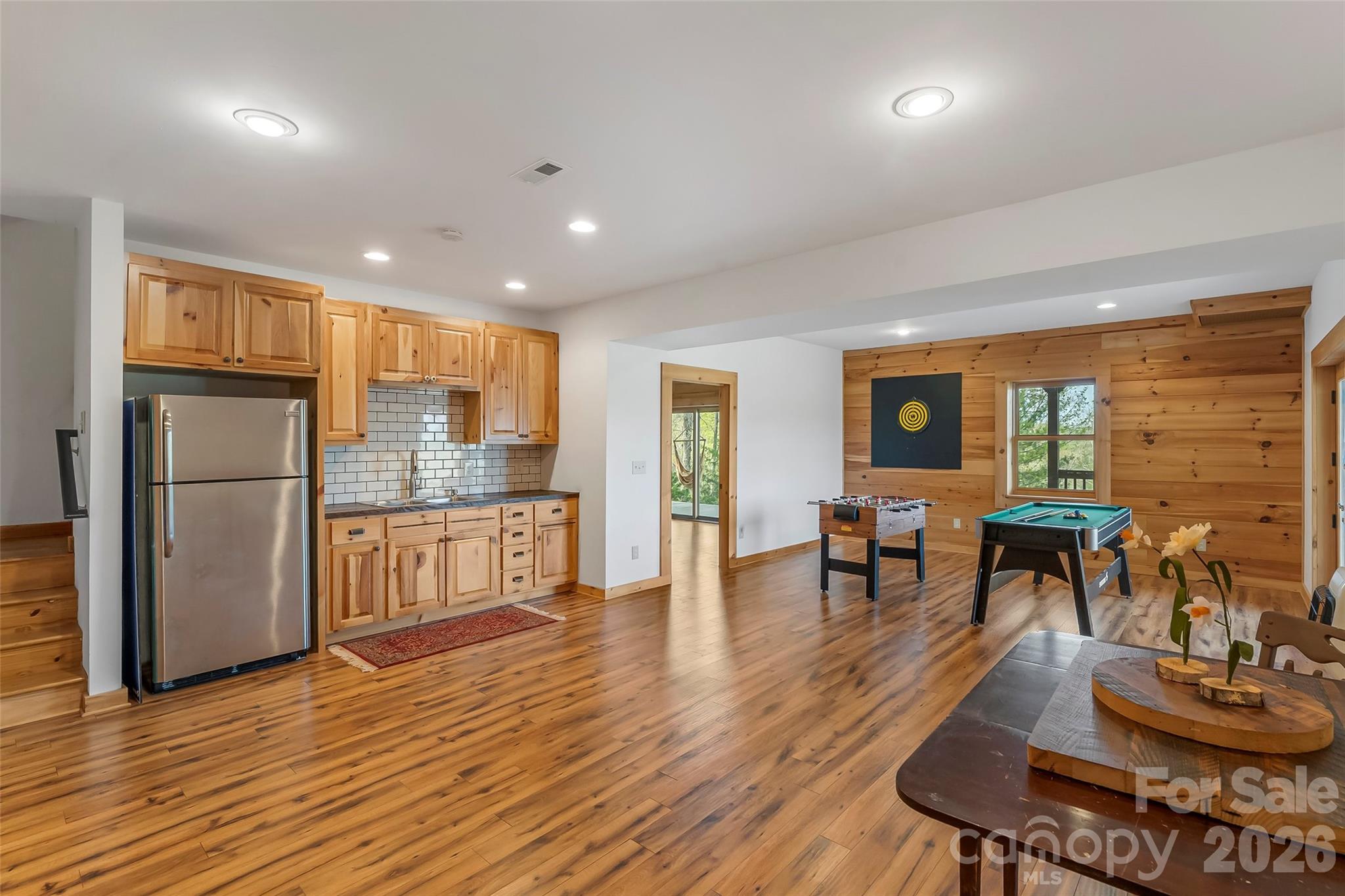 295 Outback Trail, Unit 29 Nebo, NC 28761 - Photo 30 of 46 a open kitchen with stainless steel appliances granite countertop a refrigerator a stove and a dining table with wooden floor