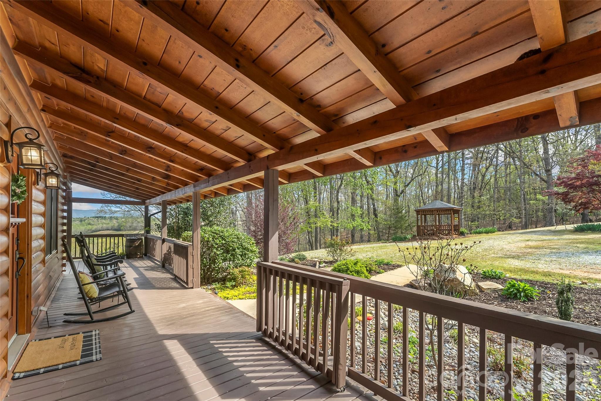 295 Outback Trail, Unit 29 Nebo, NC 28761 - Photo 6 of 46 a view of backyard with large trees and wooden fence