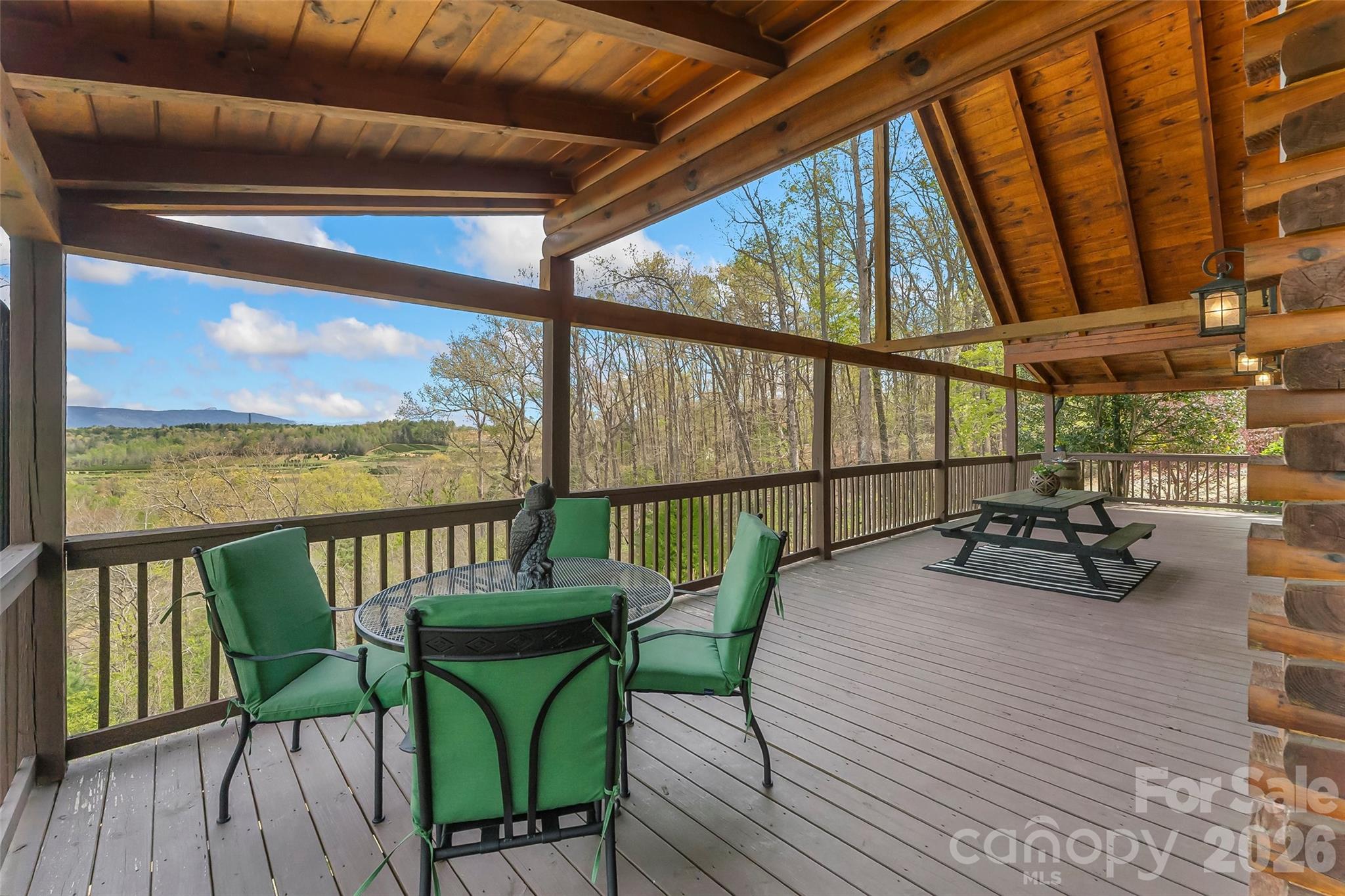 295 Outback Trail, Unit 29 Nebo, NC 28761 - Photo 10 of 46 a view of a balcony with chairs and wooden floor