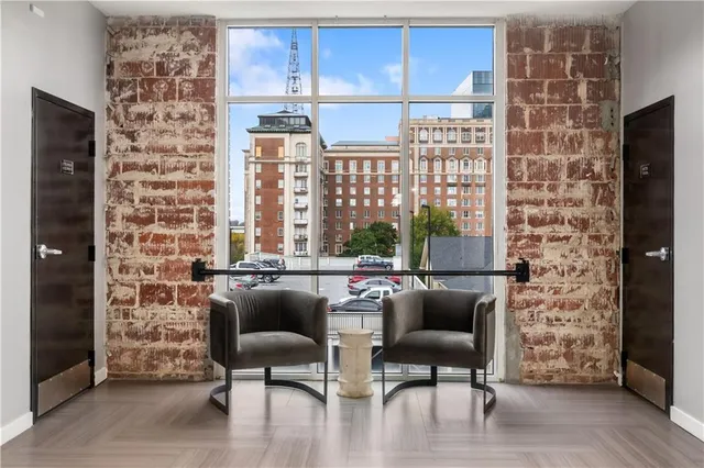 a living room with furniture a fireplace and a large window