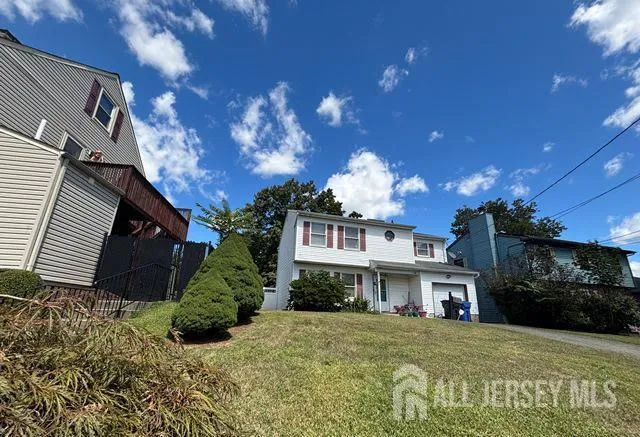 a front view of a house with a yard and a garage