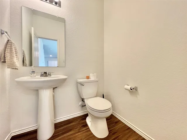 a bathroom with a sink toilet and a mirror