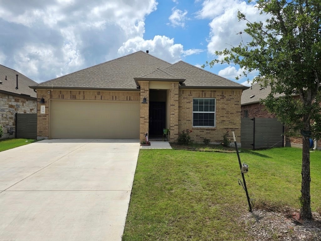 208 Wolf Springs Road Georgetown, TX 78628 - Photo 2 of 32 A well-maintained lawn welcomes you to this inviting brick home with an attached garage.
