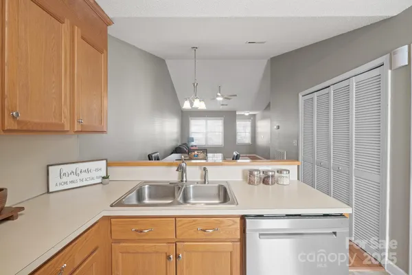 a kitchen with a sink a stove a refrigerator and cabinets