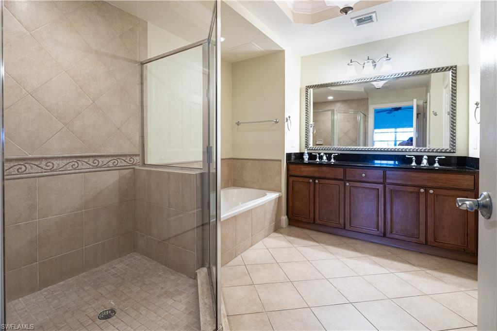 1362 Centre Ct Ridge Drive, Unit 101 Reunion, FL 34747 - Photo 16 of 25 Bathroom with dual bowl vanity, tile flooring, and separate shower and tub