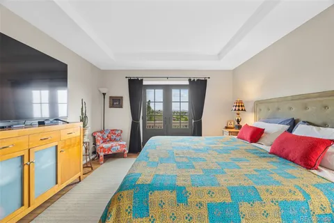 a bedroom with bed and wooden floor