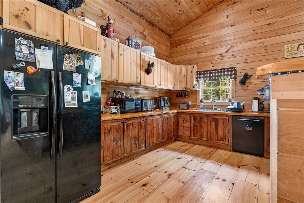 8 Oakwood Road Brimfield, MA 01010 - Photo 5 of 35 a kitchen with stainless steel appliances kitchen island granite countertop a refrigerator a sink and wooden cabinets