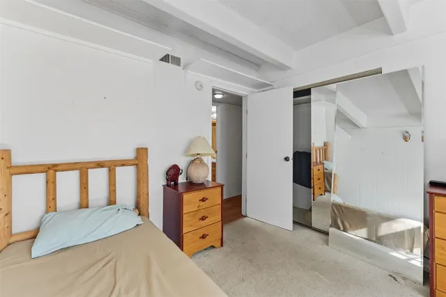 a bedroom with a bed and a cabinets