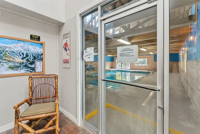 a view of a hallway with a door and the glass door