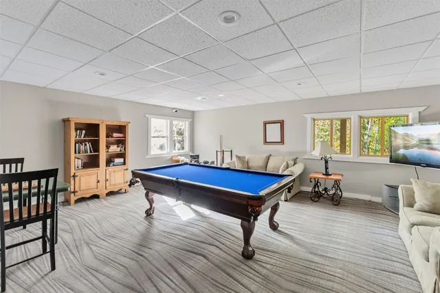 a living room with furniture a rug and a window