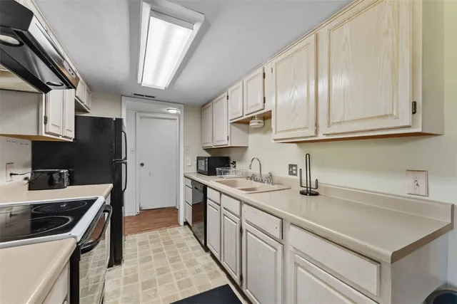 a kitchen with stainless steel appliances granite countertop a sink stove and cabinets