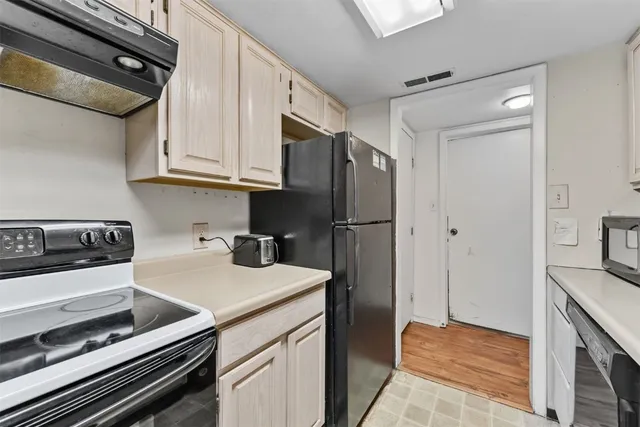 a kitchen with stainless steel appliances a sink stove and refrigerator