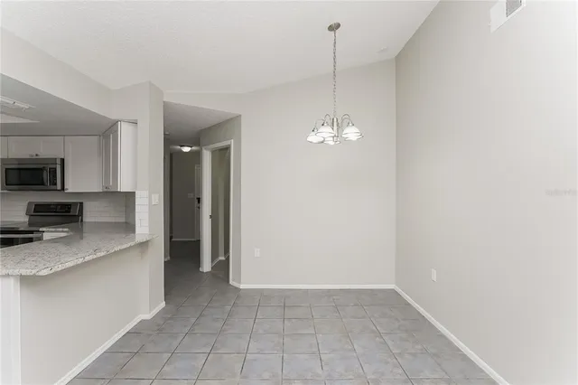 a view of a kitchen with a sink and dishwasher with wooden floor
