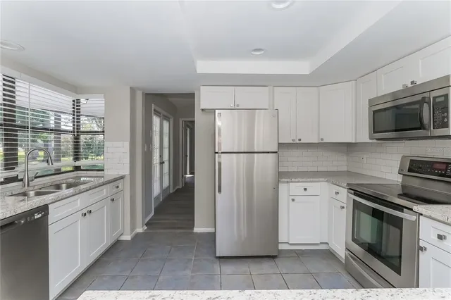 a kitchen with a refrigerator stove and sink