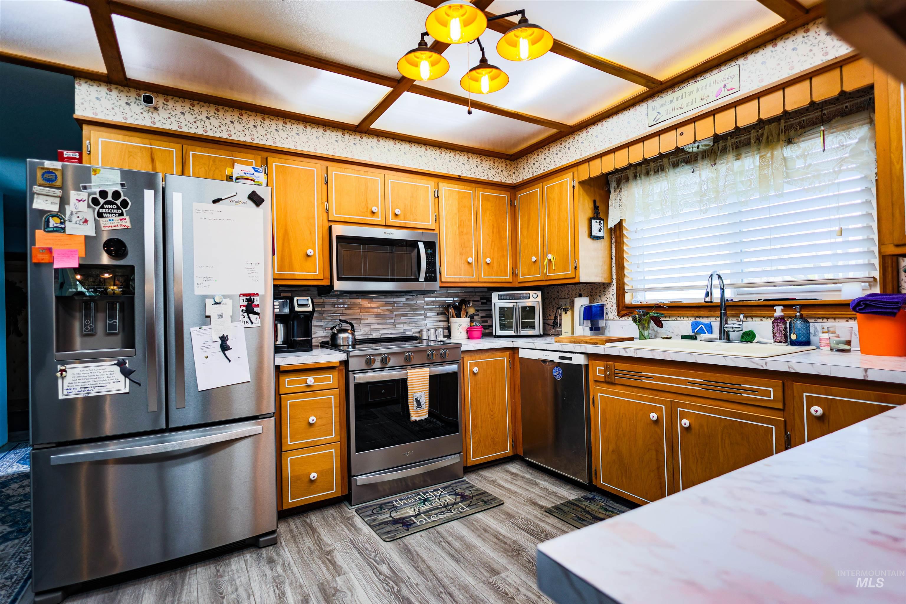 804 Maple Street Kamiah, ID 83536 - Photo 25 of 50 Kitchen with stainless steel appliances, light countertops, wood finish cabinetry, and a chandelier