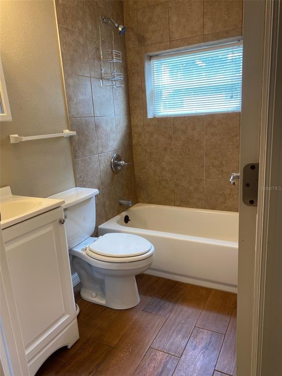 1002 East McDonald Avenue, Unit 4 Eustis, FL 32726 - Photo 9 of 13 a bathroom with a toilet a sink and a bathtub