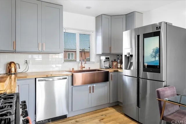 a kitchen with a refrigerator sink and cabinets
