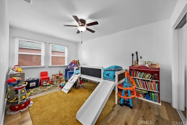 a view of a room with toys and wooden floor