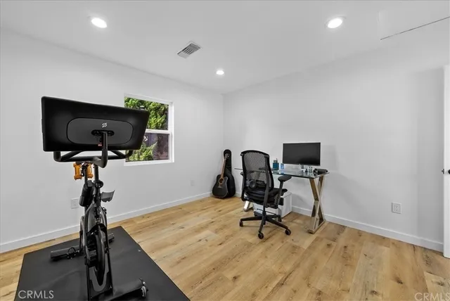 a view of a workspace with furniture and a flat screen tv