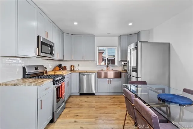 a kitchen with stainless steel appliances granite countertop a refrigerator stove microwave and sink