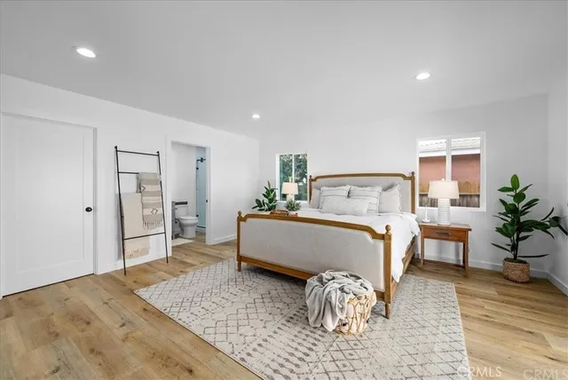 a bedroom with a bed and wooden floor