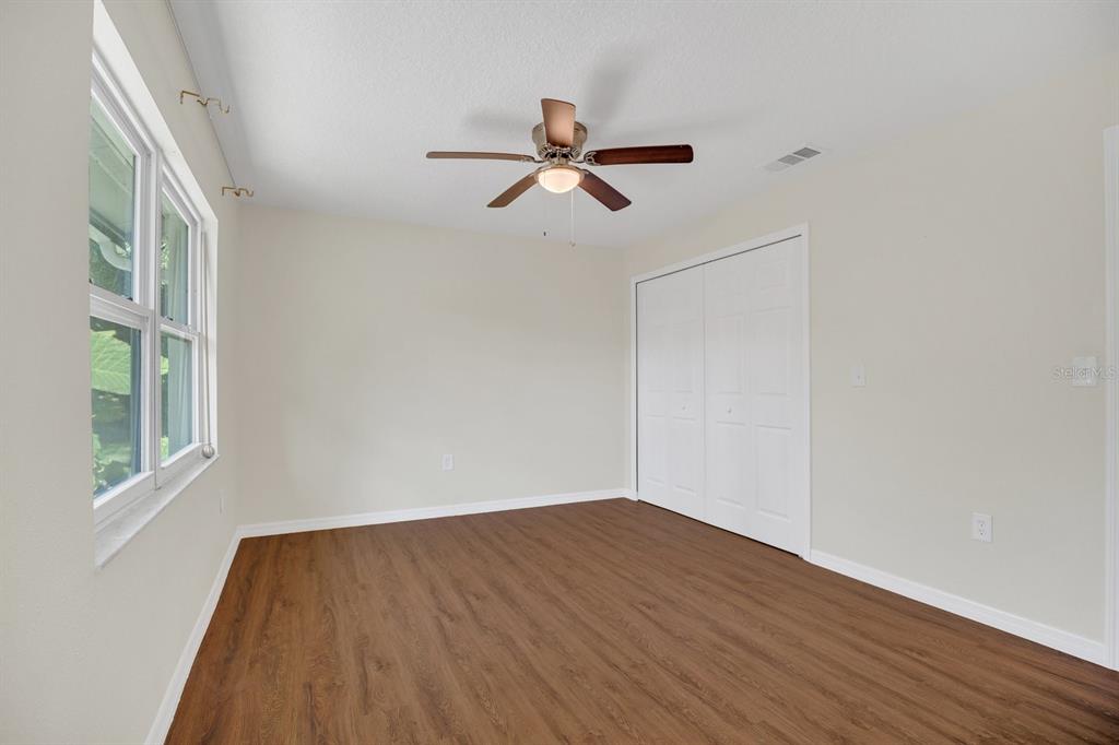 5357 Sunrise Boulevard Orlando, FL 32803 - Photo 12 of 26 a view of empty room with wooden floor and fan