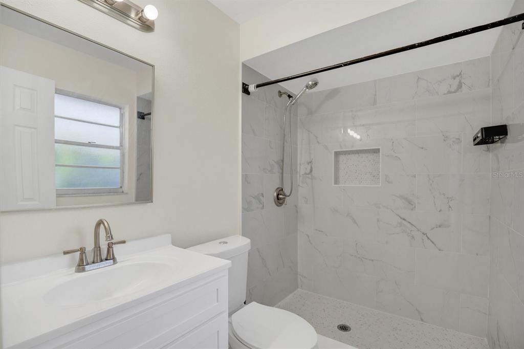 5357 Sunrise Boulevard Orlando, FL 32803 - Photo 13 of 26 a bathroom with a sink toilet and shower