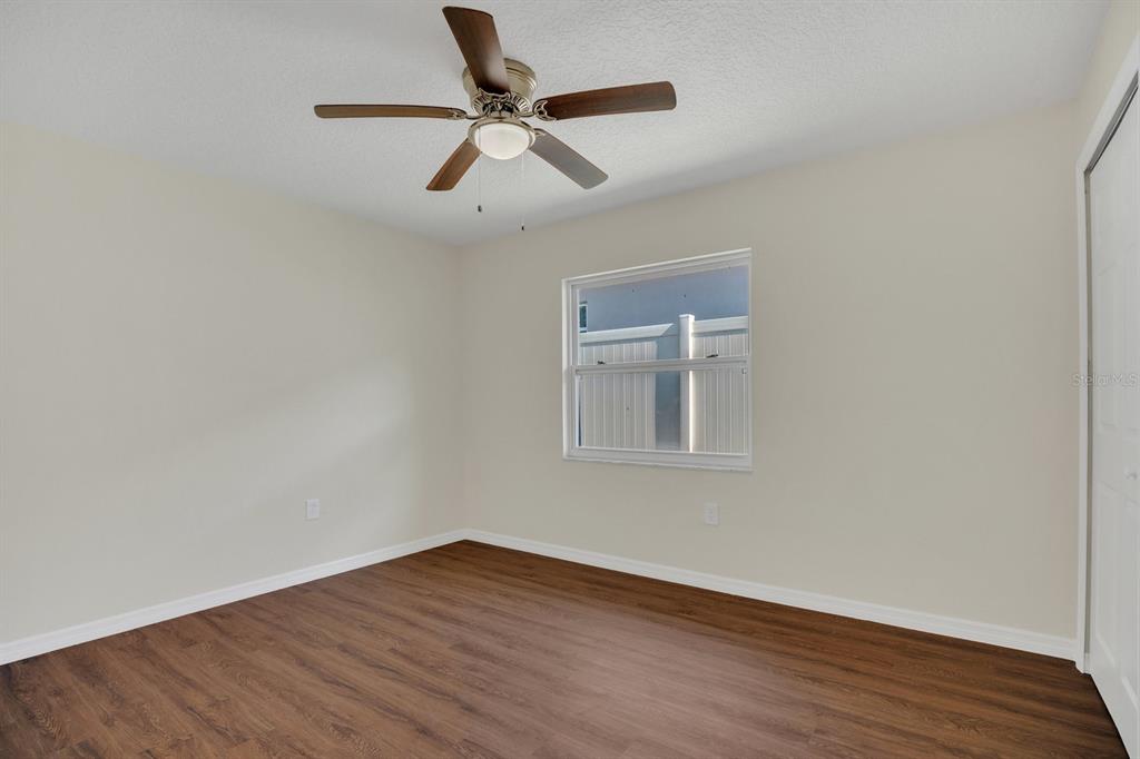 5357 Sunrise Boulevard Orlando, FL 32803 - Photo 14 of 26 a view of an empty room with wooden floor