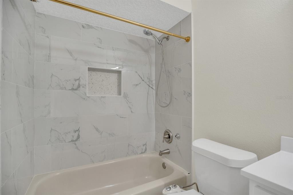 5357 Sunrise Boulevard Orlando, FL 32803 - Photo 17 of 26 a bath room with a toilet and a bath tub