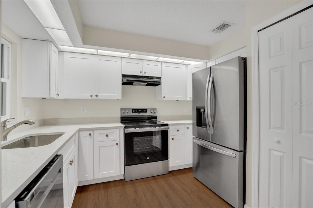 5357 Sunrise Boulevard Orlando, FL 32803 - Photo 2 of 26 a kitchen with stainless steel appliances a refrigerator sink and microwave